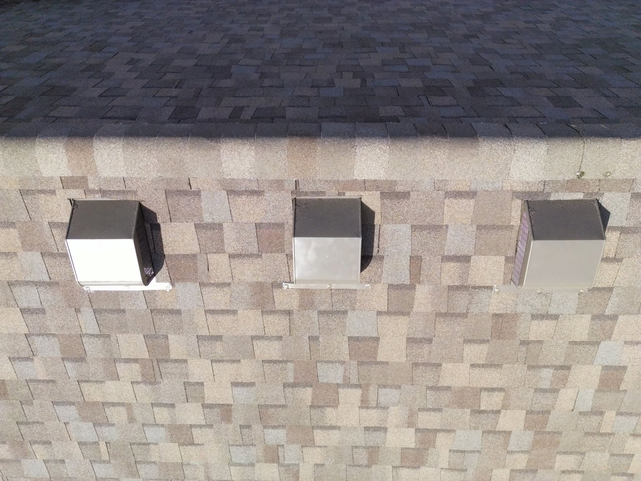 Three roof vents are visible on a shingled roof.