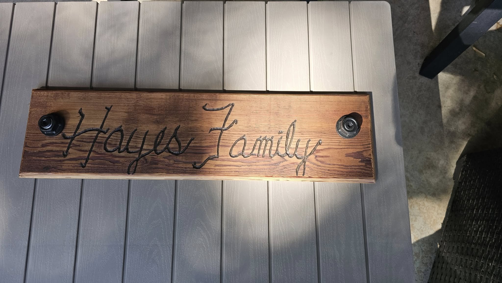 A wooden sign reading "Hayes Family" is mounted on a table.