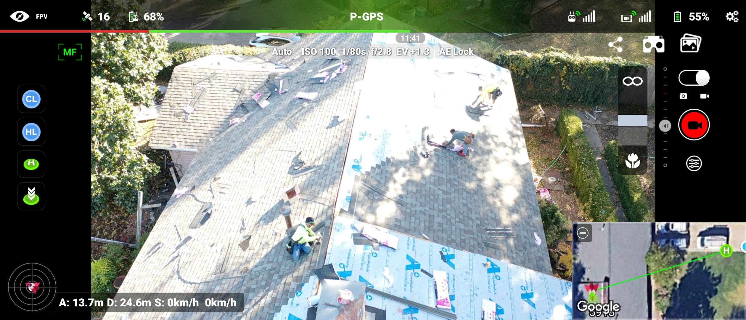 A drone captures roofers working on a house, with a map overlay showing the location.