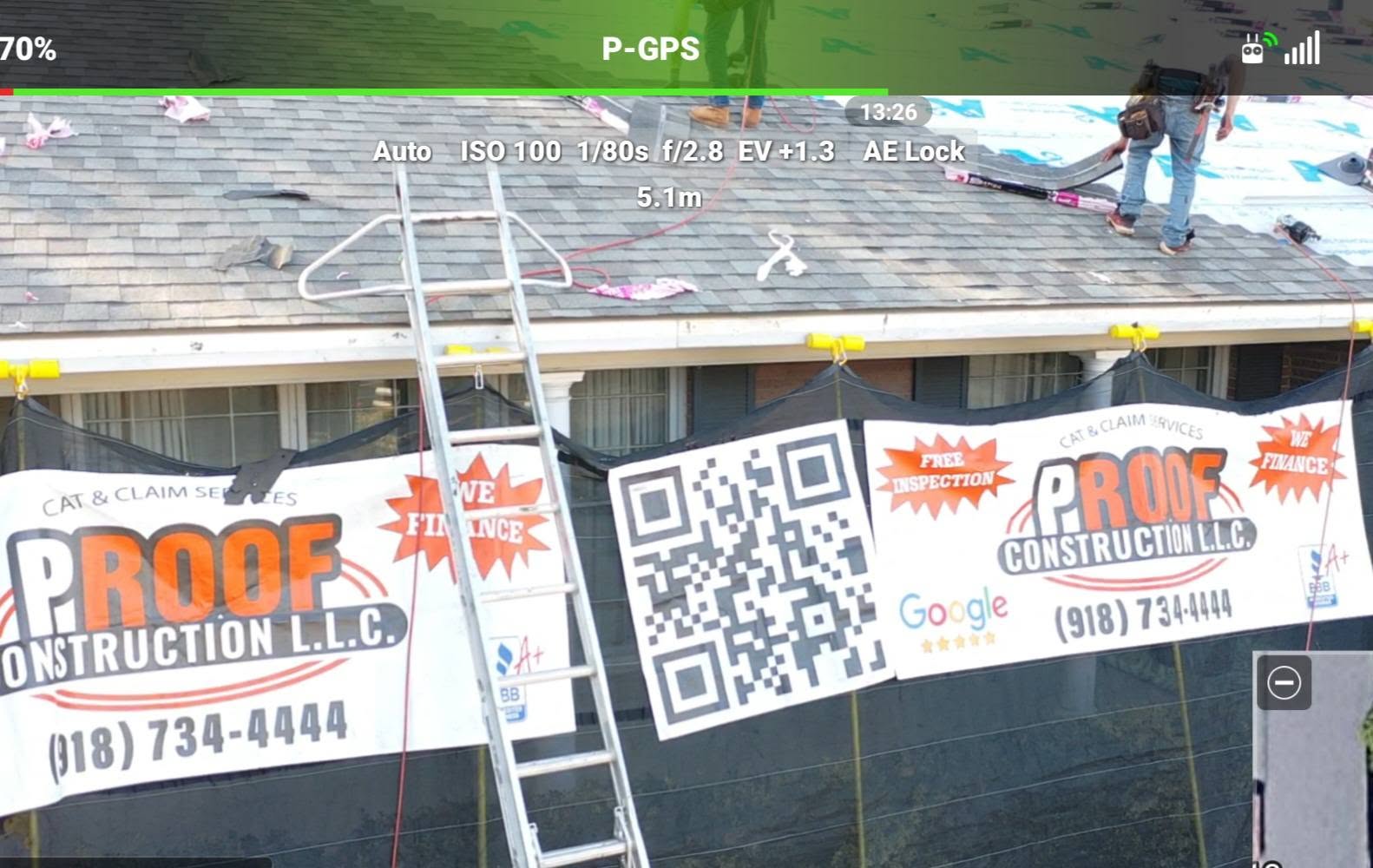 A construction worker repairs a damaged roof, with banners advertising "Proof Construction LLC" and a QR code.