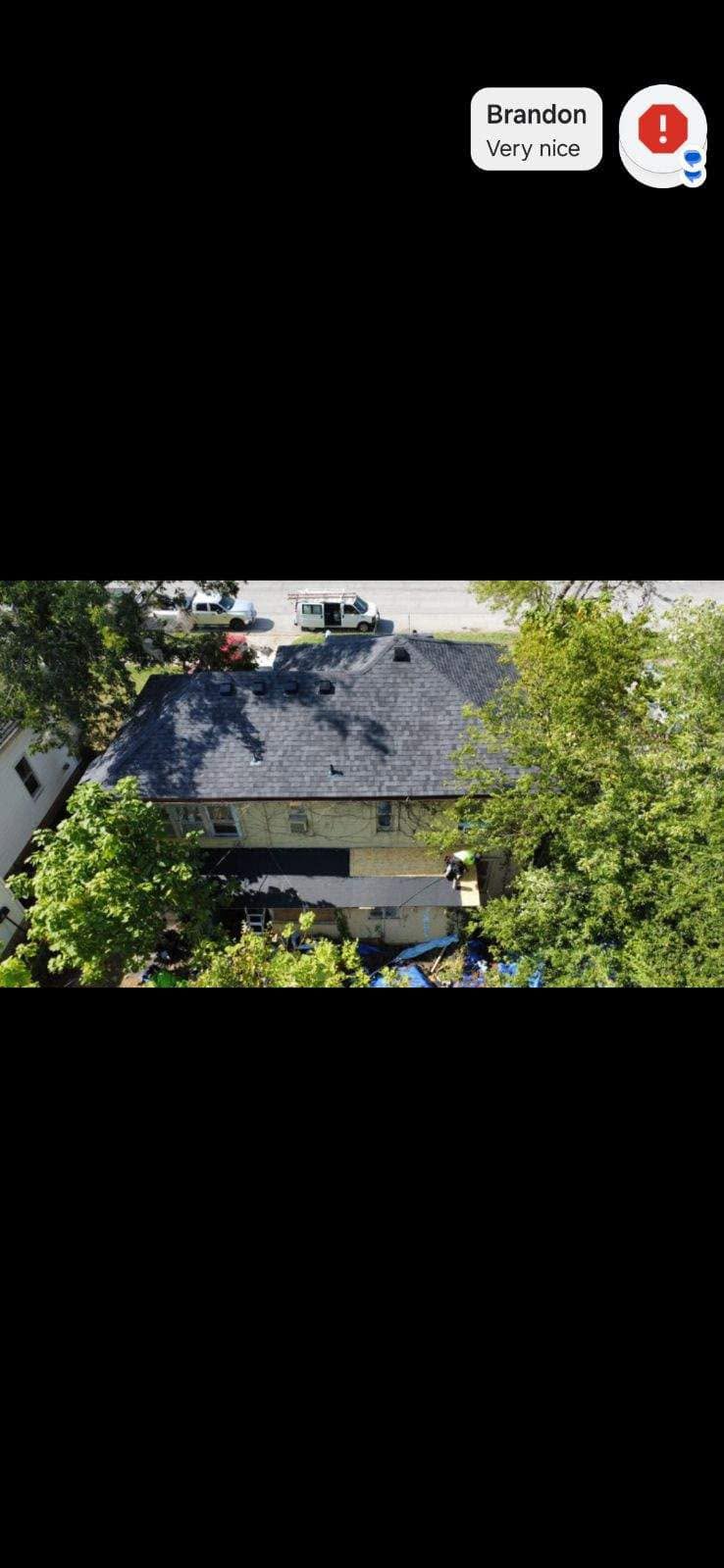 An aerial view of a house with a new roof and a message from Brandon.